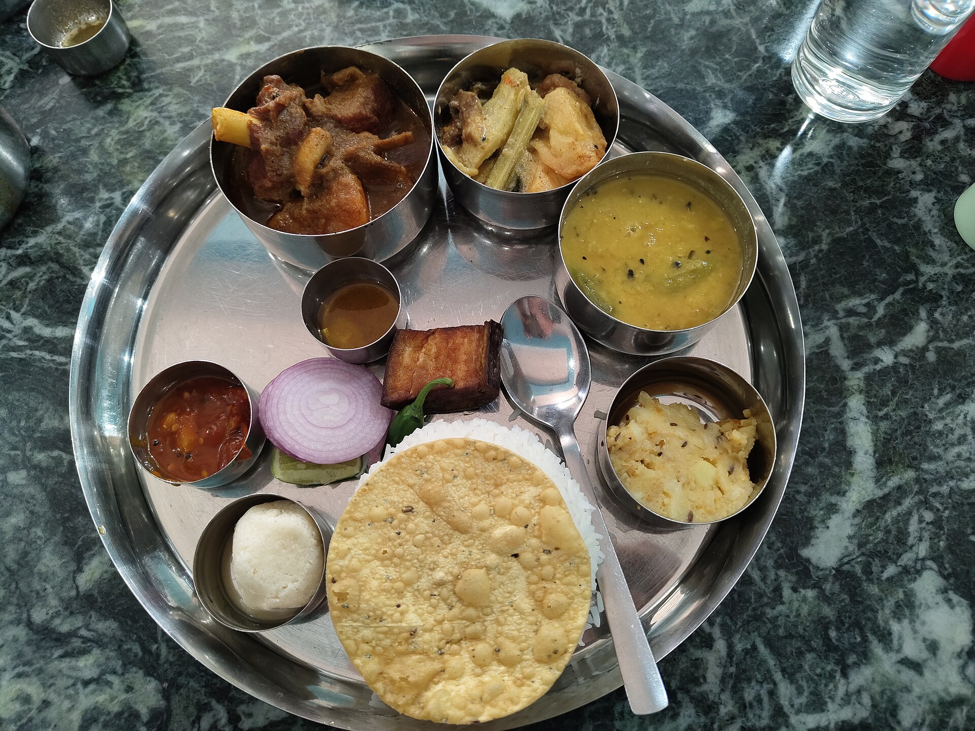 A spread of traditional Bengali dishes laid out for a feast