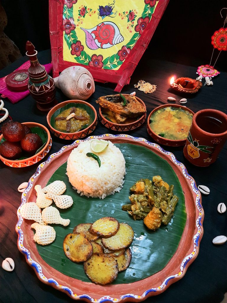 Bengali fish thali with rice, aloo bhaja, ghonto and papad