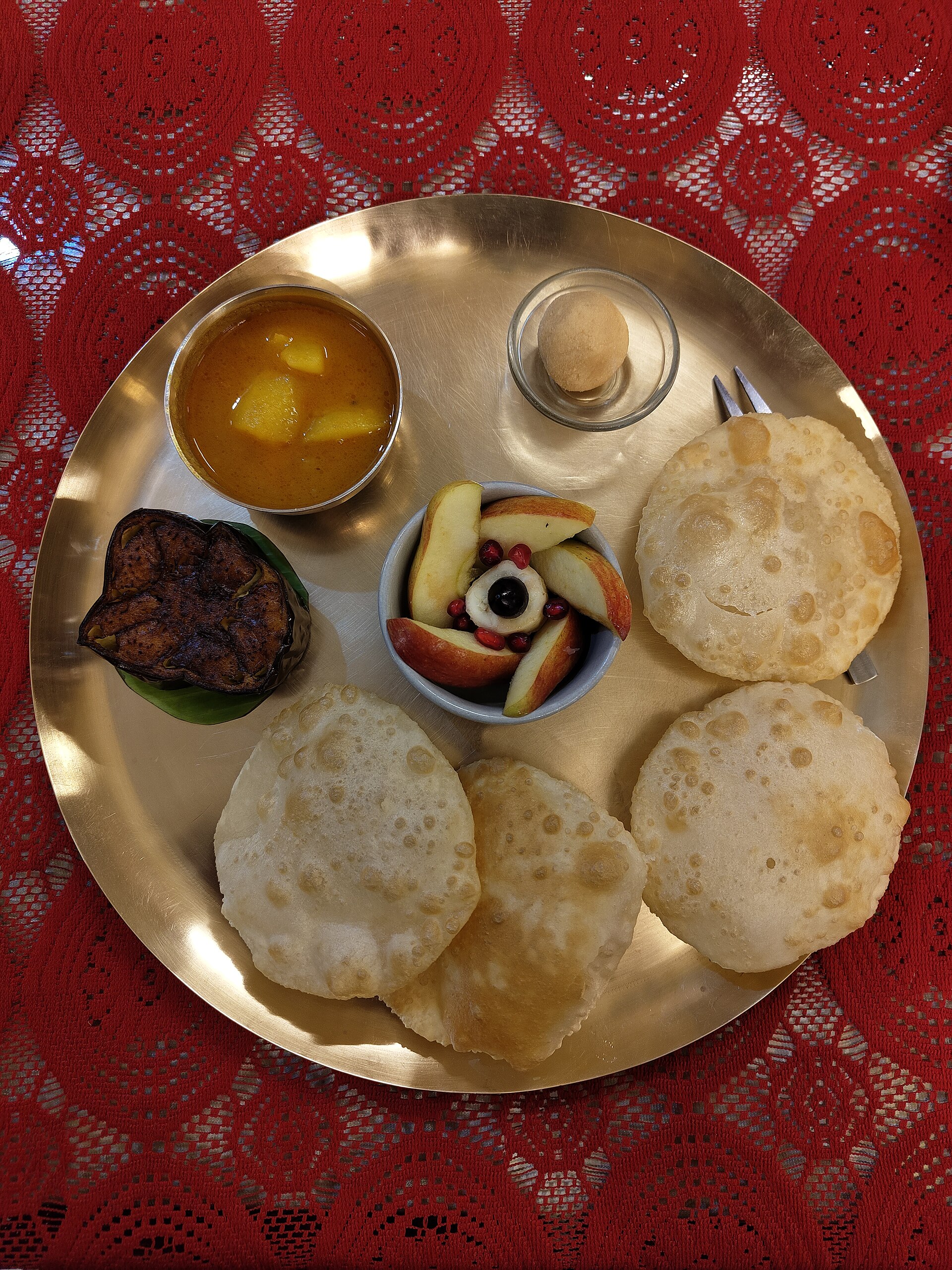 Traditional Bengali thali with rice, dal, fish and vegetables served on a plate