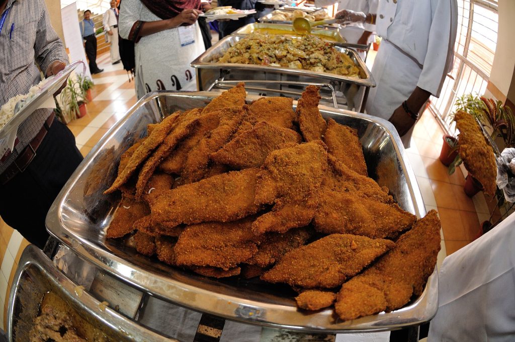 Kolkata style fish fry served with salad and mustard sauce
