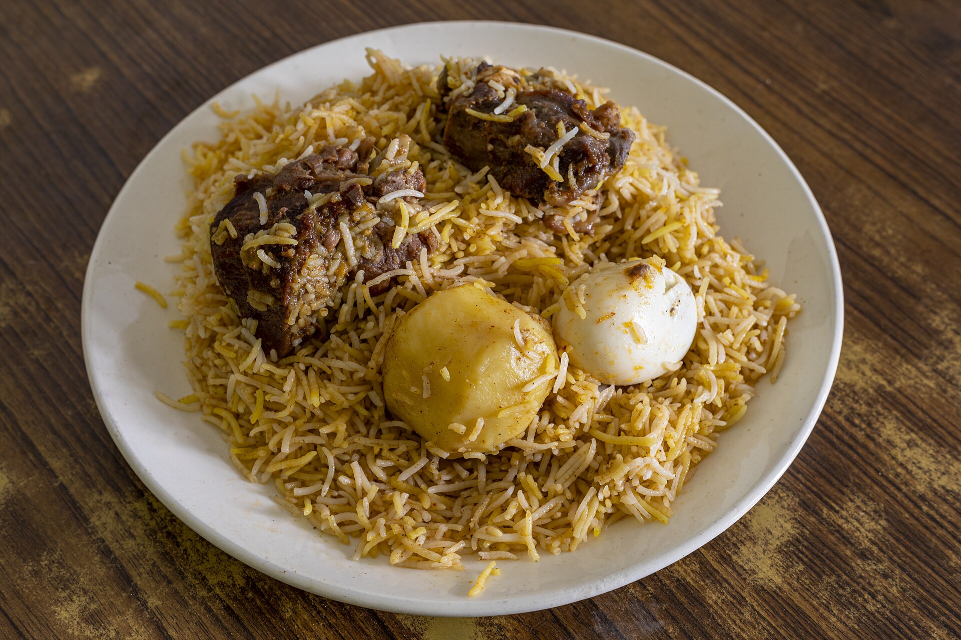Kolkata style mutton biryani with a potato and boiled egg